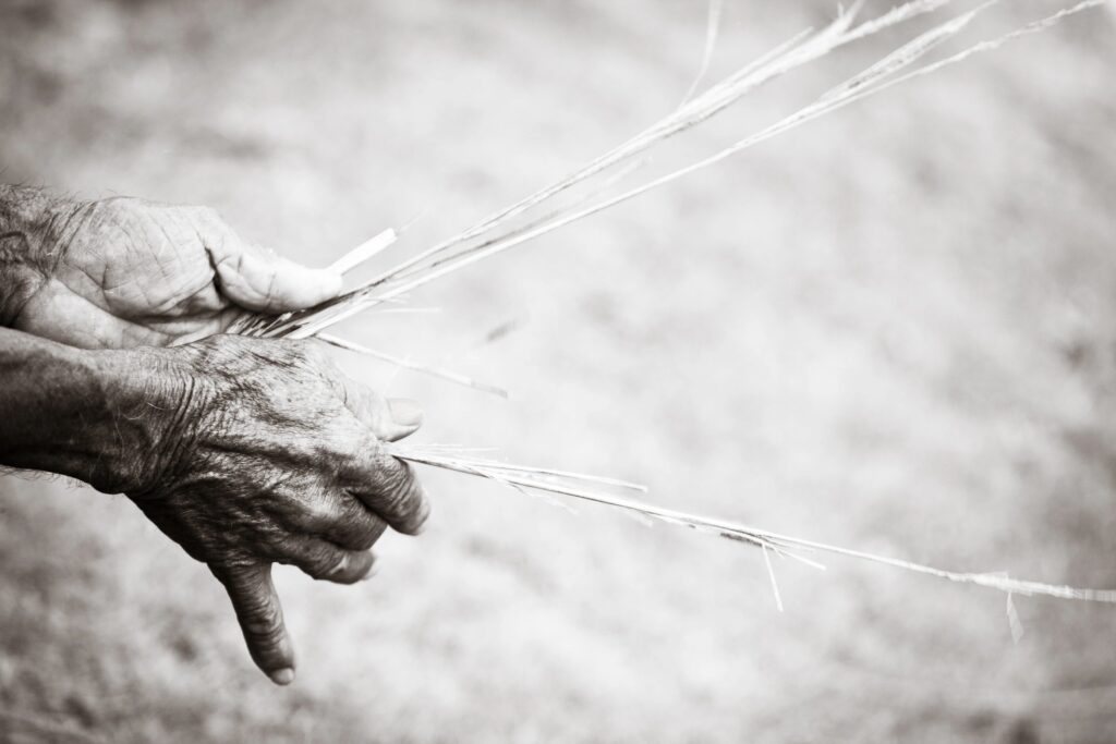 hands weaving natural fibers minimalist