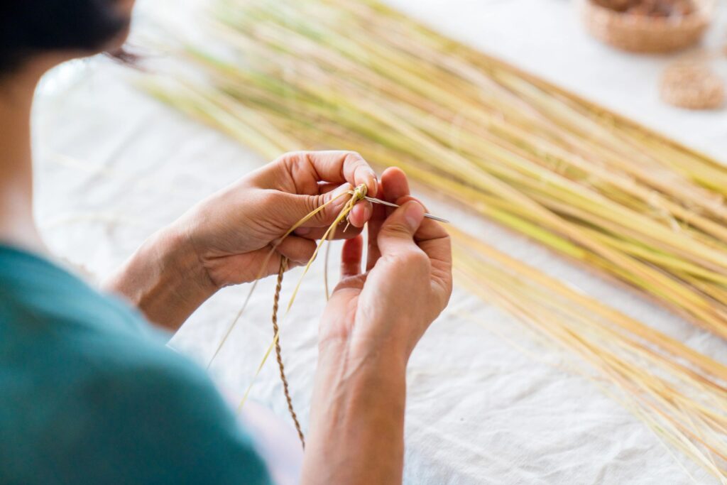 hands weaving natural fibers minimalist